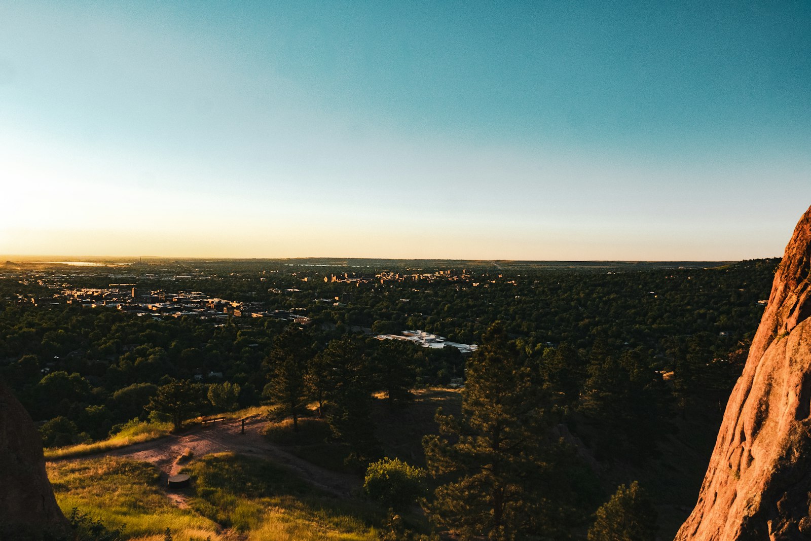 Photo: Jon Cartagena · Unsplash A Boulder home's windows glowing at golden hour