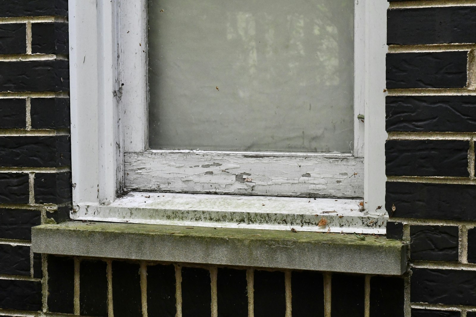Before: a window clouded with hard-water spots and grime